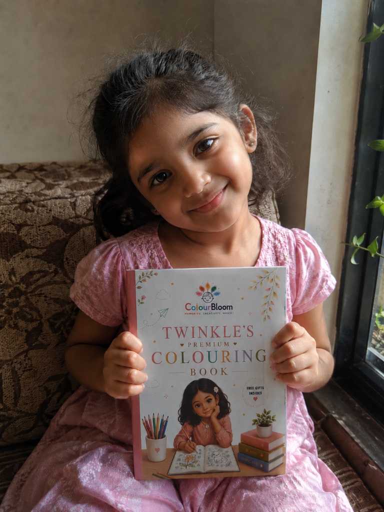 Twinkle holding her premium personalised colouring book